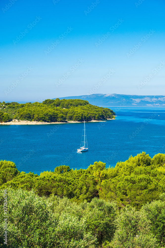 Aerial view of beautiful blue bay on Adriatic seascape paradise, sail boat in lagoon on the island of Cres in Croatia
