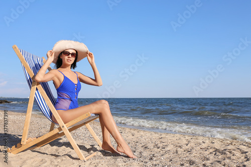 Beautiful young woman in swimsuit on sea beach © Pixel-Shot