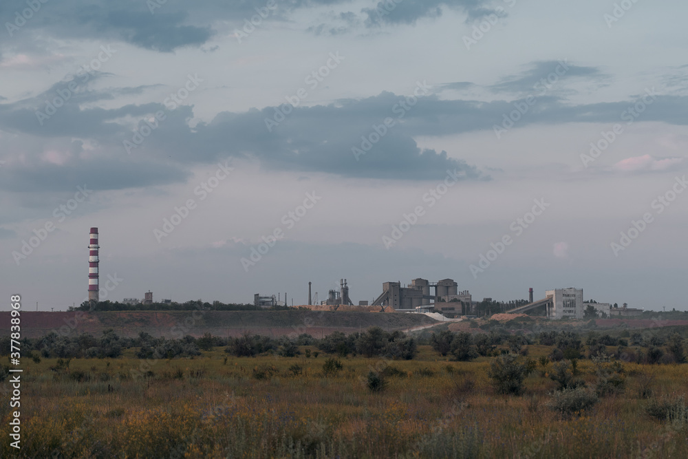 old plant factory in distance. landscape with industrial building and pipe