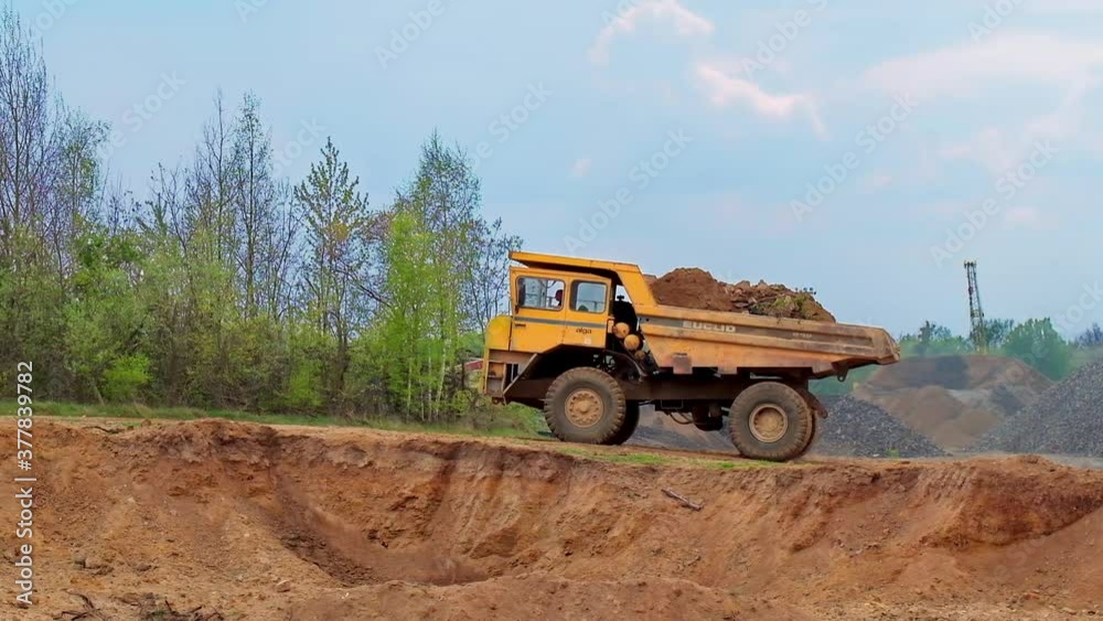 Large mining truck. Large quarry truck in the background of hills Large mining truck. Large quarry truck in the background of hills