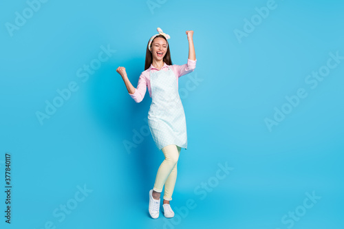 Full size photo of delighted girl celebrate lottery win raise fists scream yeah wear good look clothes isolated over blue color background