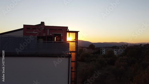 Panning shot of Reggello middle school buildings at sunset. End summer sunny day. Tuscany hills close to Vallombrosa monastery, Italy photo