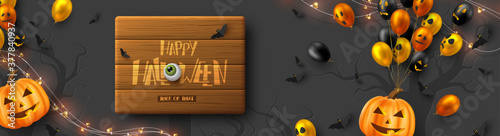 Happy Halloween horizontal banner. Glossy balloons with monster faces, pumpkins, flying bats and eyes. Handwritten lettering on wooden plank, dark background. Vector illustration.
