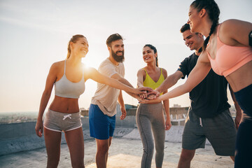 Group of fit healthy friends, people exercising together outdoor
