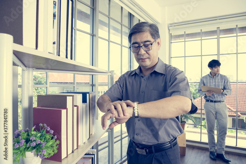 Wallpaper Mural Handsome senior businessman has serious expression because the team members do not punctuality.  He boring after working hard in office.  Leadership concept. Torontodigital.ca