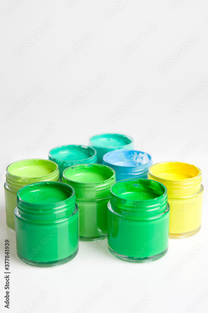 green, yellow and blue paints on white background green, yellow and blue paints on white background