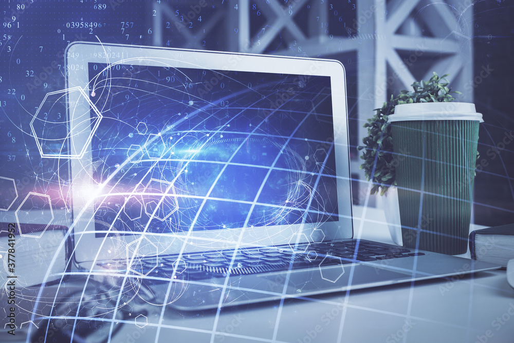 Double exposure of desktop with computer and world map hologram. International data network concept.