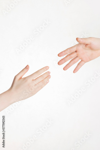 hands reaching toward each other on white background