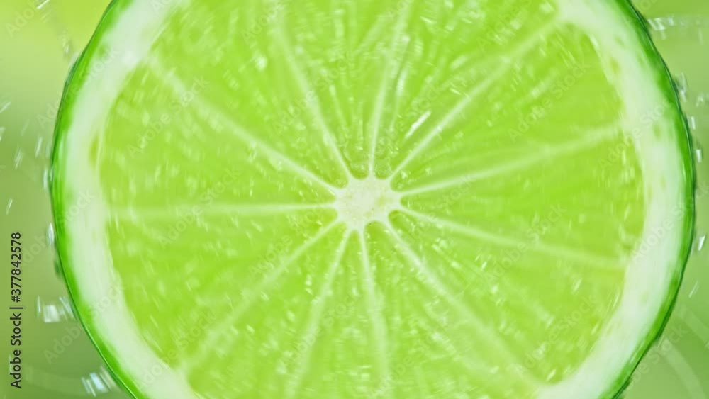 Super Slow Motion Shot of Splashing Water on Rotating Lime Slice at 1000fps. Super Slow Motion Shot of Splashing Water on Rotating Lime Slice at 1000fps.