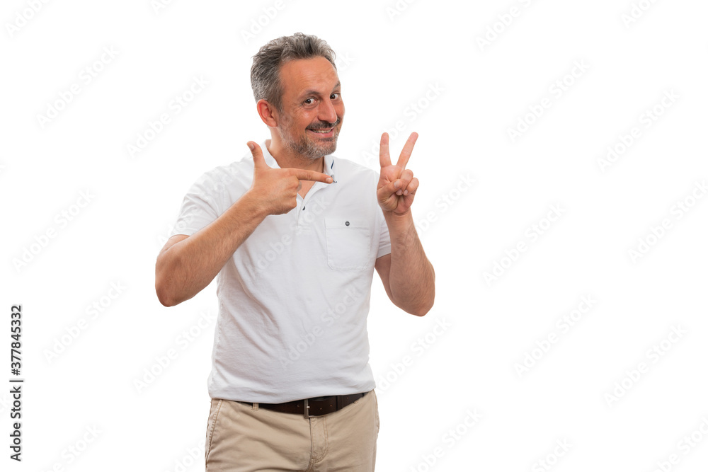 Cheerful man pointing index finger at number two gesture Cheerful man pointing index finger at number two gesture