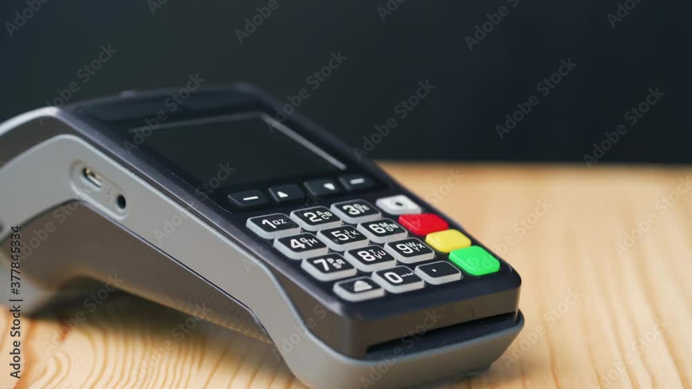 Contactless payment with smartphone. Wireless payment concept. Close-up, woman using smartphone cashless wallet NFC technology to pay order on bank terminal. Contactless payment with smartphone. Wireless payment concept. Close-up, woman using smartphone cashless wallet NFC technology to pay order on bank terminal.