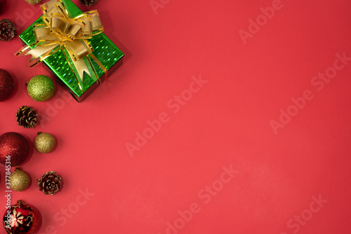 New Year's toys with a gift on a red background. Holiday concept. copy space for text. View from above