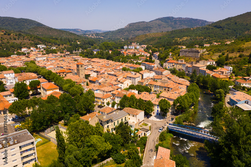 Scenic aerial view of residential areas of French commune of Quillan on Aude River in summer, Occitanie