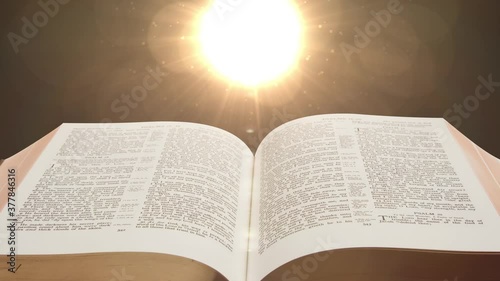 the bible scriptures and optical flares, the holy book of Christians photo