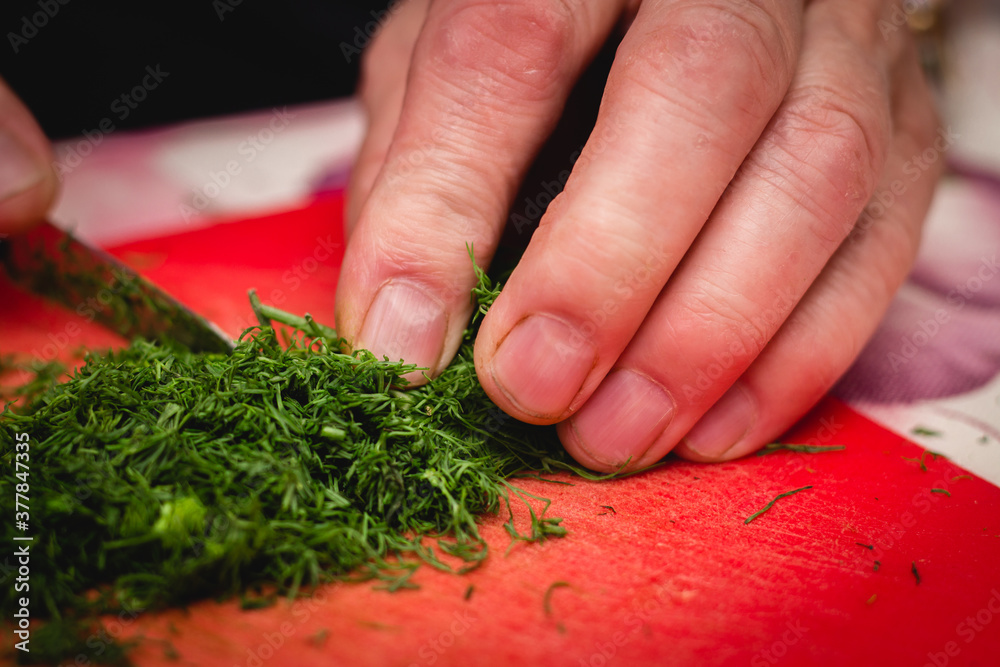 Greens chopping. Cook hand with the knife Greens chopping. Cook hand with the knife