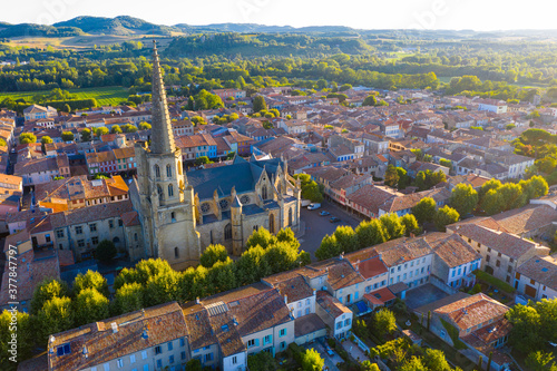 View from drone of houses of Mirepoix town and cathedral of St-Maurice at sunny summer day, France