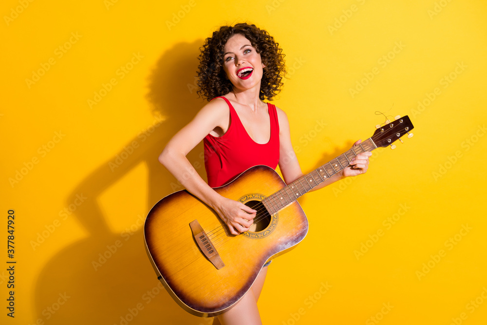 Obraz premium Portrait of her she nice attractive lovely talented popular cheerful cheery wavy-haired girl playing guitar rest live performance isolated bright vivid shine vibrant yellow color background