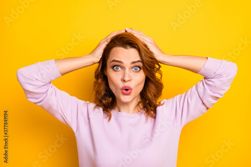 Photo of beautiful crazy ginger lady hands on head open mouth listen good news unexpected shocking surprise wear pink pullover isolated yellow color background