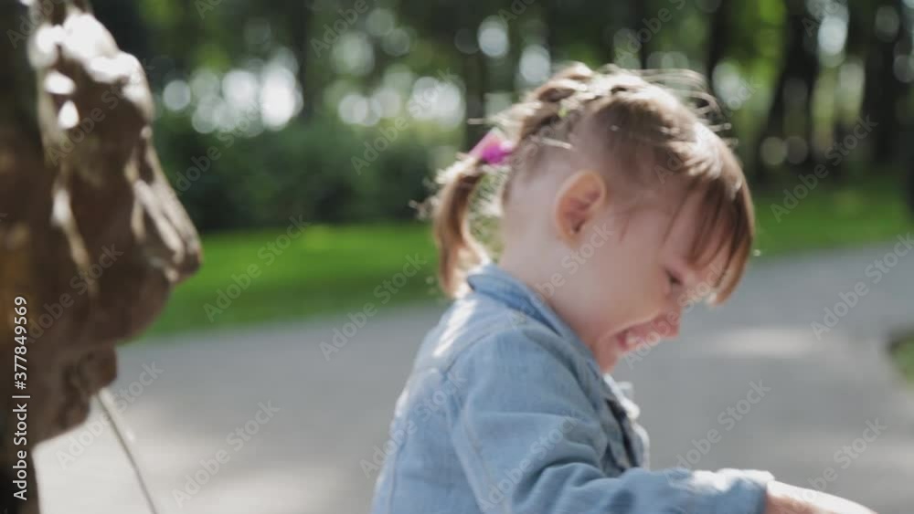 Little girl at the drinking fountain in the park. Little girl at the drinking fountain in the park.