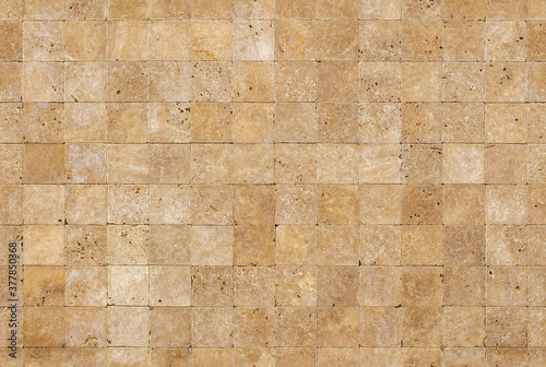 Seamless wall background with Yellow natural sandstone tiles stiched together with clay
