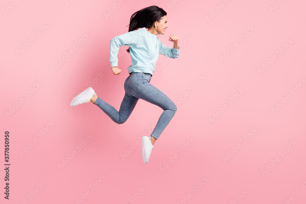 Full size profile photo lady jumping running speed race wear blue pullover jeans isolated pink color background