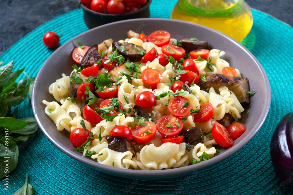 Pasta creste with grilled eggplant, cherry tomatoes and herbs. Delicious warm salad.