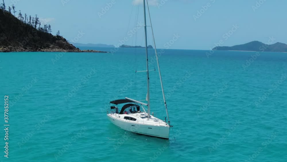 Drone Orbits a White Sail Boat with the Whitsunday Islands in the Background, QLD Australia Drone Orbits a White Sail Boat with the Whitsunday Islands in the Background, QLD Australia