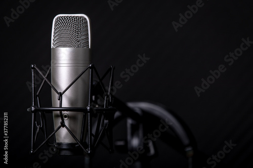 Sound and voice recording studio with nobody. Vintage style microphone and tools for record in room with noise reduction and resonance absorb foam wall in background for good acoustic with copy space