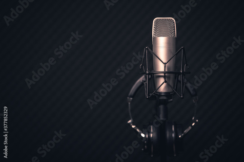 Sound and voice recording studio with nobody. Vintage style microphone and tools for record in room with noise reduction and resonance absorb foam wall in background for good acoustic with copy space