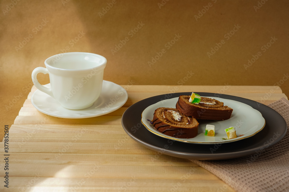 sweet roll in a plate and marmalades and a cup of tea sweet roll in a plate and marmalades and a cup of tea