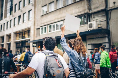 People protesting with signs on the city streets. Manifestation of activists. 