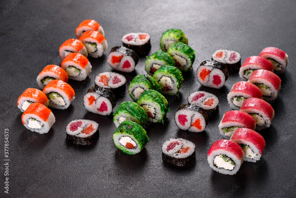 Fresh delicious beautiful sushi rolls on a dark background Fresh delicious beautiful sushi rolls on a dark background