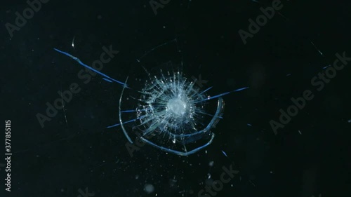 A bullet hitting bullet-proof glass - slow motion photo