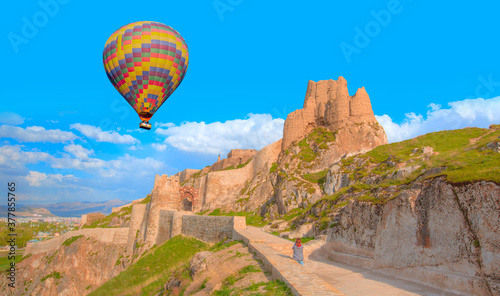 Hot air balloon flying over Ruins of ancient fortress in Van - The old castle of Van - Van, Turkey