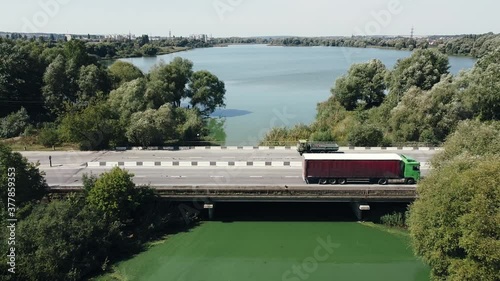 Wallpaper Mural A large truck and cars are passing over the bridge near the river and forest Torontodigital.ca