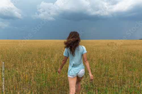 Young Woman In Wheat Field At Summer