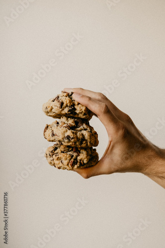 Hand holding three cookies