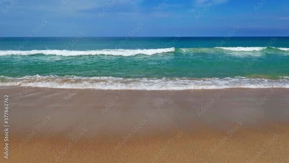 Soft focus - Tropical ocean water & calm sea wave with white foam crashed exotic golden sandy beach in summer or spring sunlight & sun ray on wispy blue sky background at daylight sunny sunshine day Soft focus - Tropical ocean water & calm sea wave with white foam crashed exotic golden sandy beach in summer or spring sunlight & sun ray on wispy blue sky background at daylight sunny sunshine day