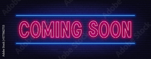 Coming soon neon script sign on brick wall background .