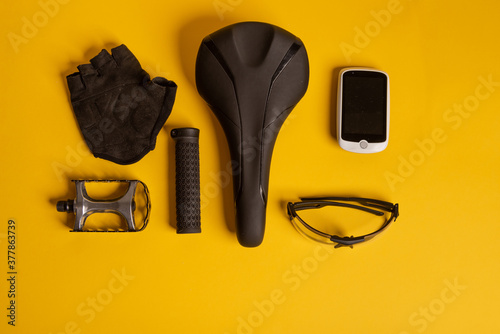 Bicycle, Cycling accessories on the yellow background. view from above.