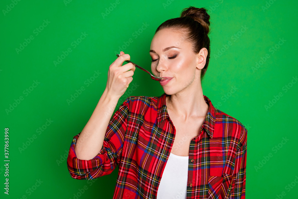 Close-up portrait of nice attractive dreamy girl in checked shirt licking spoon eating healthy yummy tasty homemade fresh lunch food isolated bright vivid shine vibrant green color background