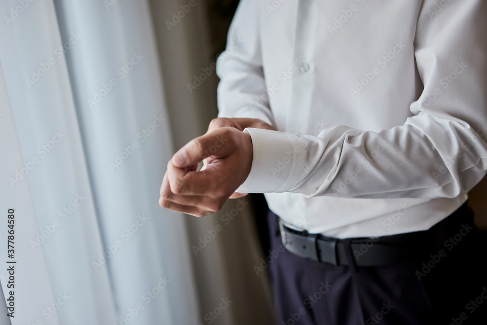 businessman dresses white shirt, male hands closeup,groom getting ready in the morning before wedding ceremony businessman dresses white shirt, male hands closeup,groom getting ready in the morning before wedding ceremony