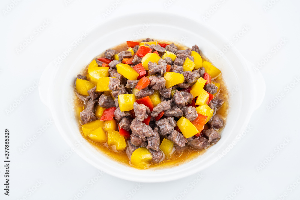 Diced beef with bell pepper on a dish of home cooking on white background Diced beef with bell pepper on a dish of home cooking on white background