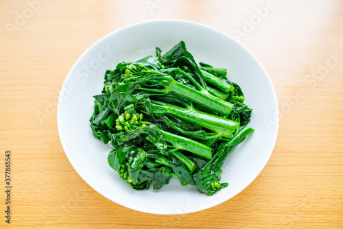 A dish of Chinese vegetable stir-fried Chinese kale and cabbage heart on a wooden table