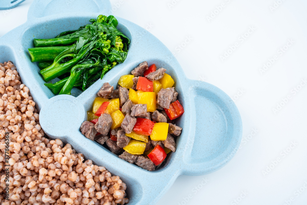 Nutritional meal for children on a plate on white background