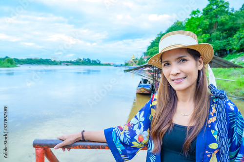 A Woman Traveler with Mekong River Background at Golden Triangle photo