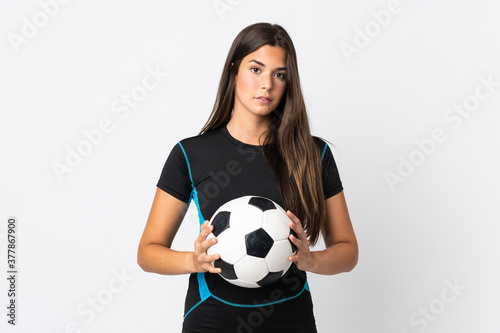 Young brazilian woman isolated on white background with soccer ball © luismolinero