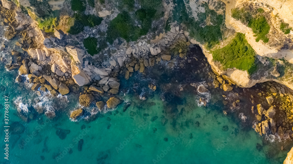 Aerial bird view of waves breaking against cliffs in La Breña, Spain