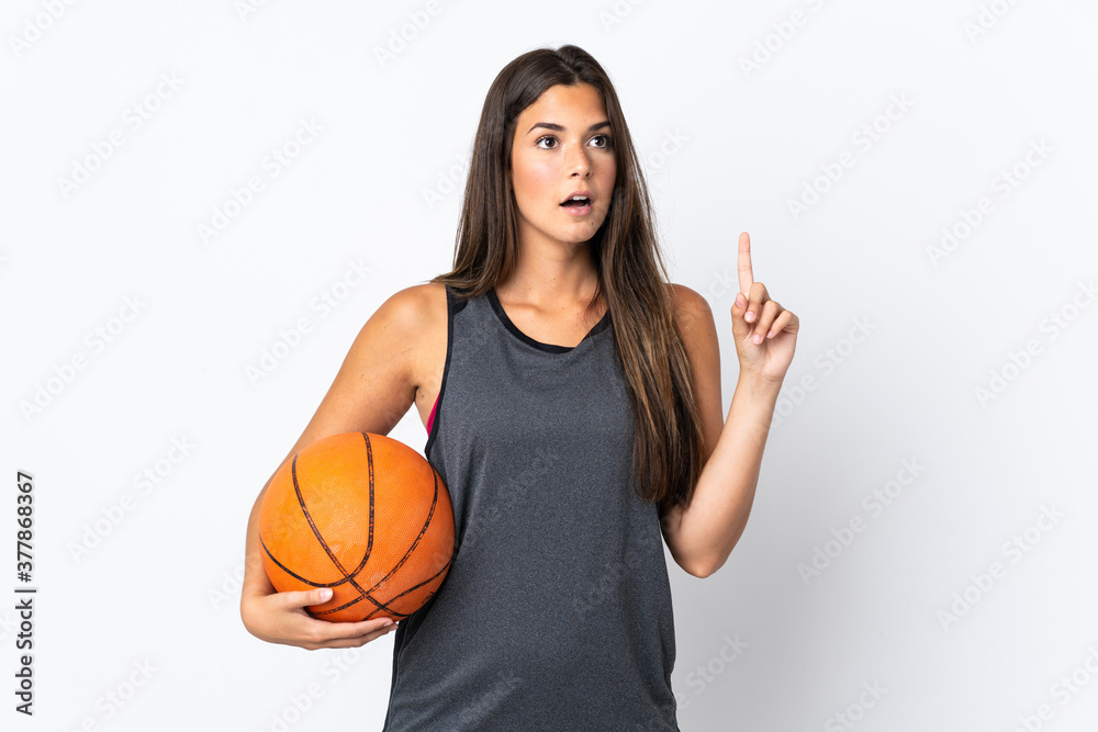 Young brazilian woman playing basketball isolated on white background thinking an idea pointing the finger up Young brazilian woman playing basketball isolated on white background thinking an idea pointing the finger up