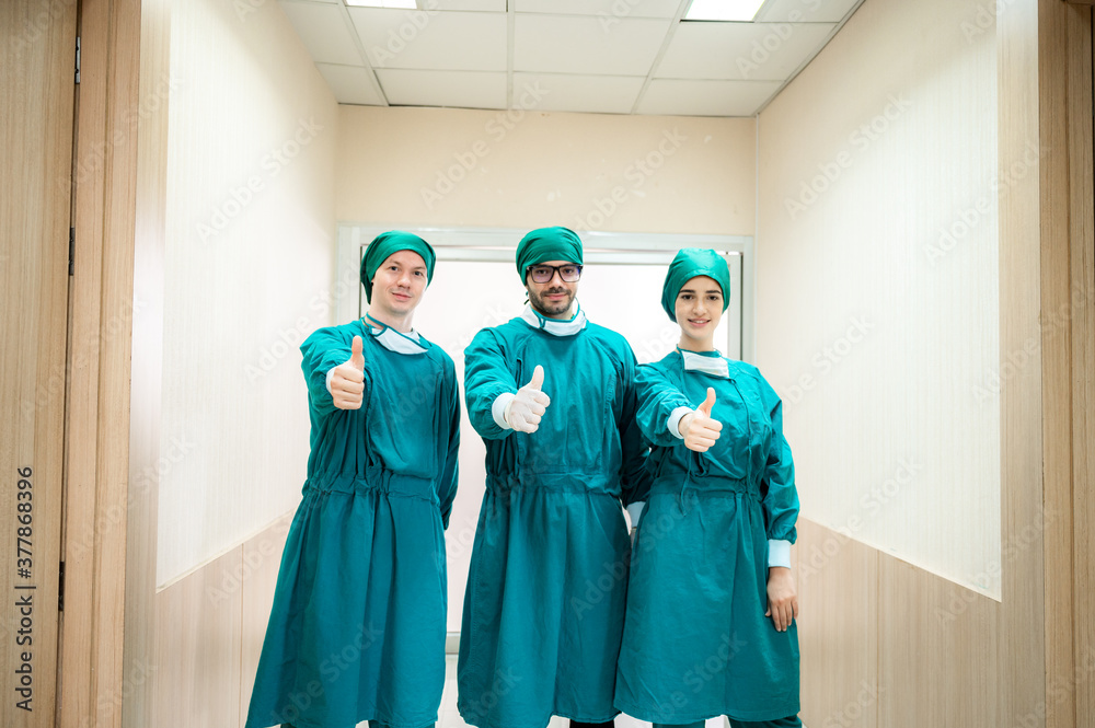 Group of doctors wearing surgical gown after success surgery